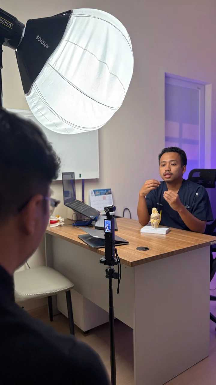 Behind-the-scenes filming of a doctor during a clinic video session